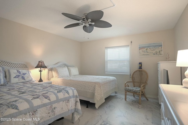 bedroom featuring marble finish floor and ceiling fan