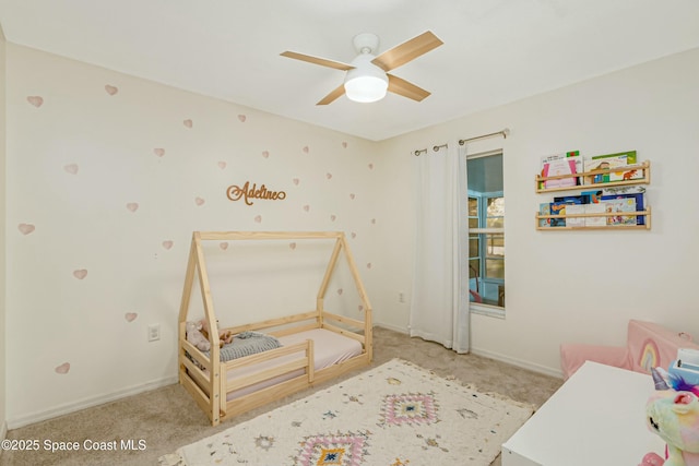 carpeted bedroom with a ceiling fan and baseboards