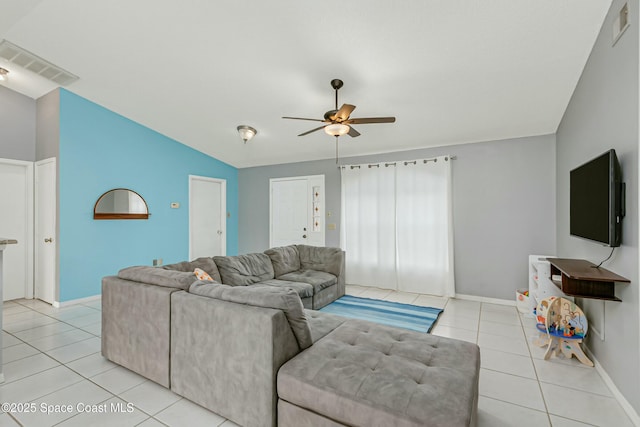 living room with lofted ceiling, visible vents, and light tile patterned floors