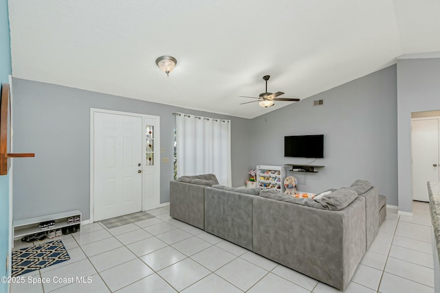 living room featuring light tile patterned floors, baseboards, visible vents, a ceiling fan, and lofted ceiling