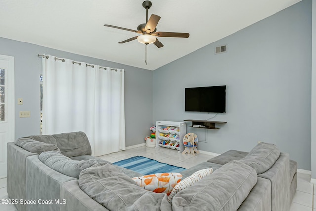 tiled living room with lofted ceiling, baseboards, visible vents, and a ceiling fan