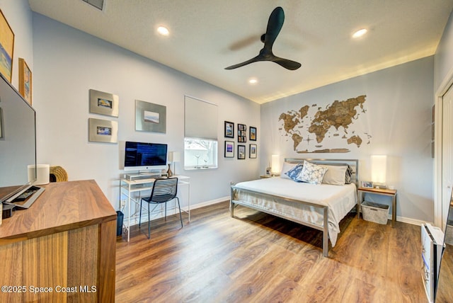 bedroom with a ceiling fan, baseboards, wood finished floors, and recessed lighting