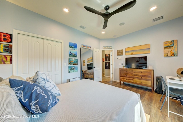 bedroom featuring recessed lighting, a closet, visible vents, and wood finished floors