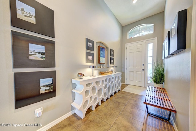 foyer with tile patterned flooring and baseboards