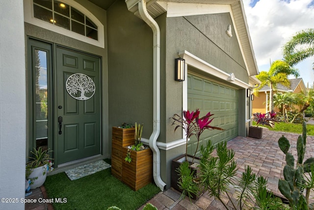 entrance to property featuring stucco siding