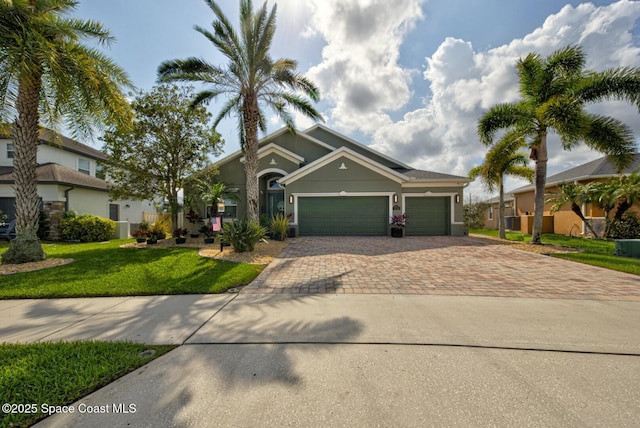 view of front facade with decorative driveway, an attached garage, stucco siding, and a front yard