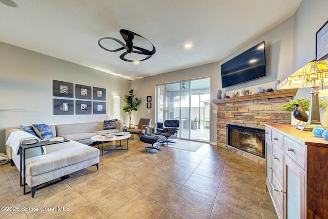 tiled living area featuring a fireplace, a ceiling fan, and recessed lighting