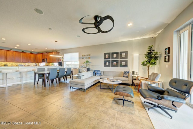 living room featuring light tile patterned flooring and recessed lighting