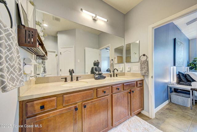 bathroom with visible vents, a sink, and double vanity