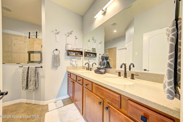 bathroom with baseboards, visible vents, a sink, and tile patterned floors