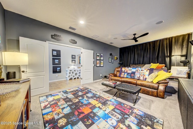 living room featuring baseboards, visible vents, and a ceiling fan