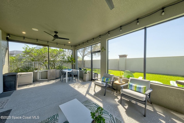 sunroom featuring a ceiling fan