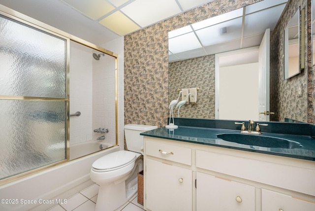 full bathroom featuring wallpapered walls, toilet, tile patterned floors, combined bath / shower with glass door, and vanity