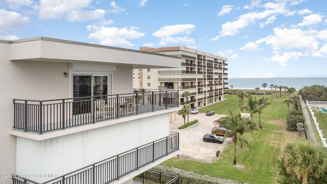 view of community featuring a water view and fence