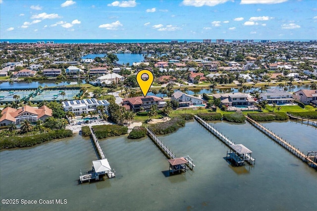 drone / aerial view featuring a water view and a residential view