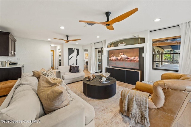 living area with recessed lighting, light wood-style floors, and a ceiling fan