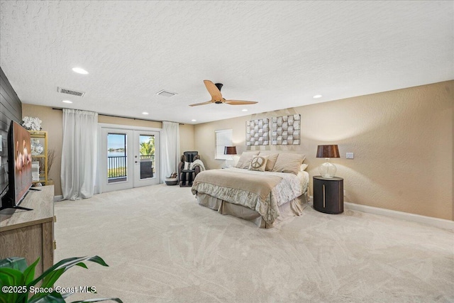 carpeted bedroom with baseboards, visible vents, french doors, a textured ceiling, and access to outside