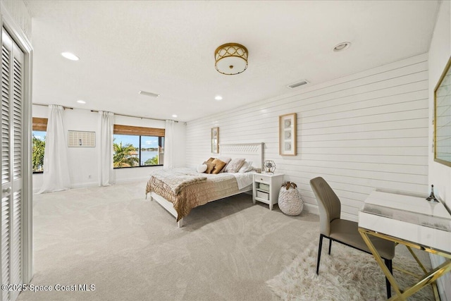 bedroom featuring recessed lighting, visible vents, carpet, and wood walls