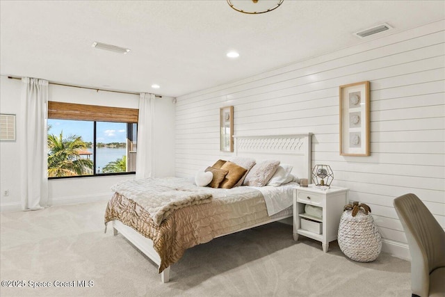 bedroom featuring recessed lighting, light colored carpet, visible vents, and baseboards