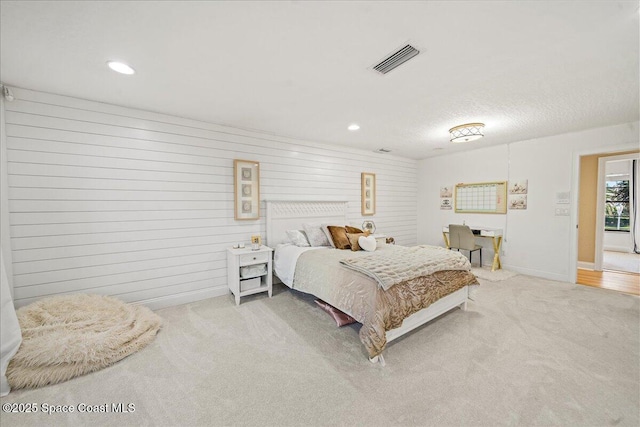 carpeted bedroom with recessed lighting, visible vents, and baseboards