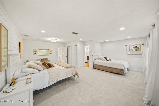 bedroom featuring recessed lighting, visible vents, and light colored carpet