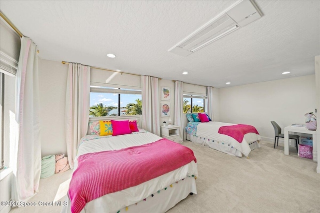 carpeted bedroom featuring recessed lighting, a textured ceiling, and attic access