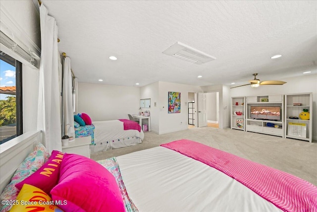 carpeted bedroom with recessed lighting and a textured ceiling