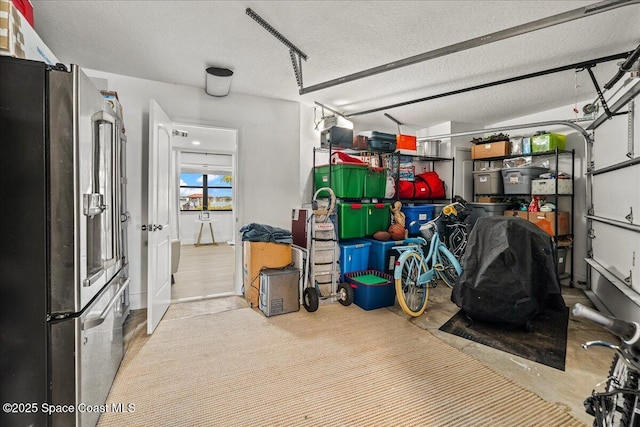 garage featuring stainless steel fridge