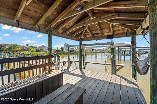 view of dock featuring boat lift and a water view