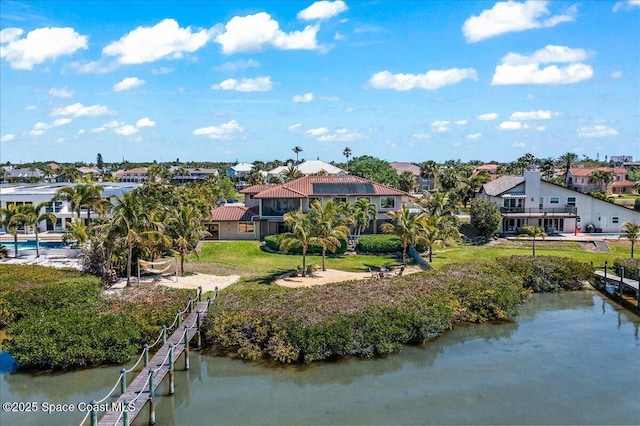 drone / aerial view featuring a residential view and a water view