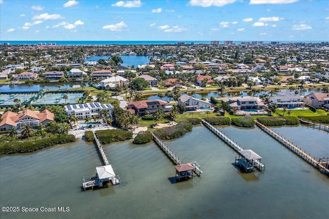 birds eye view of property with a residential view and a water view