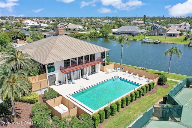 pool featuring a patio area, a residential view, a water view, and fence private yard