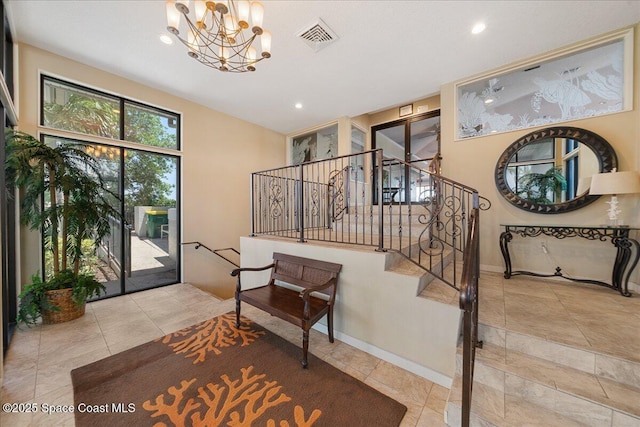 staircase featuring recessed lighting, baseboards, visible vents, and a chandelier