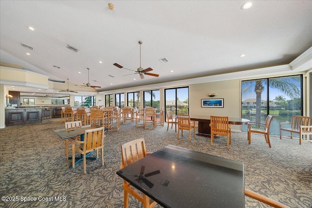 dining room with visible vents, ceiling fan, and carpet flooring