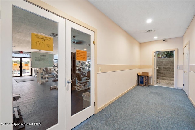 hall with visible vents, carpet, baseboards, stairs, and recessed lighting