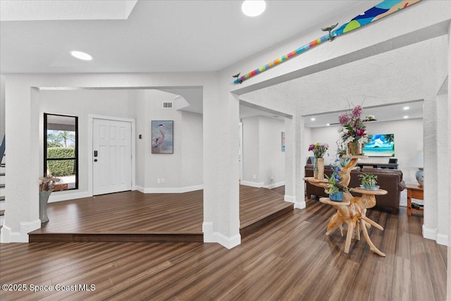 foyer entrance featuring recessed lighting, visible vents, baseboards, and wood finished floors