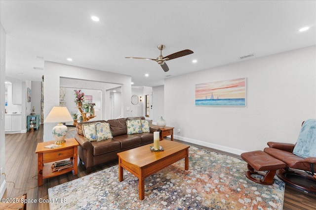 living room featuring baseboards, visible vents, a ceiling fan, wood finished floors, and recessed lighting