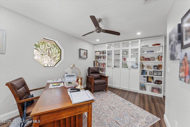 office space with a textured ceiling, a textured wall, wood finished floors, a ceiling fan, and baseboards