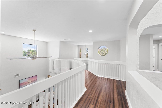 corridor with recessed lighting, visible vents, wood finished floors, and an upstairs landing