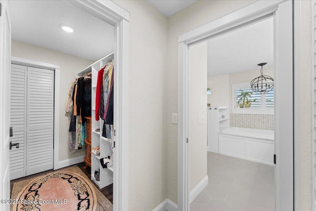 spacious closet featuring tile patterned floors