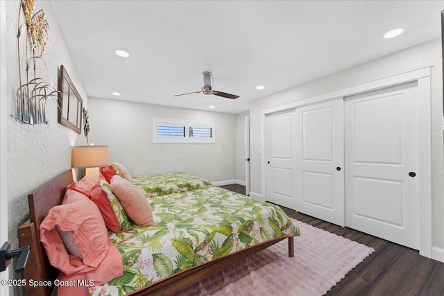 bedroom with a closet, baseboards, dark wood-style flooring, and recessed lighting