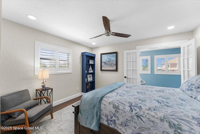 bedroom with recessed lighting, a textured ceiling, baseboards, and wood finished floors