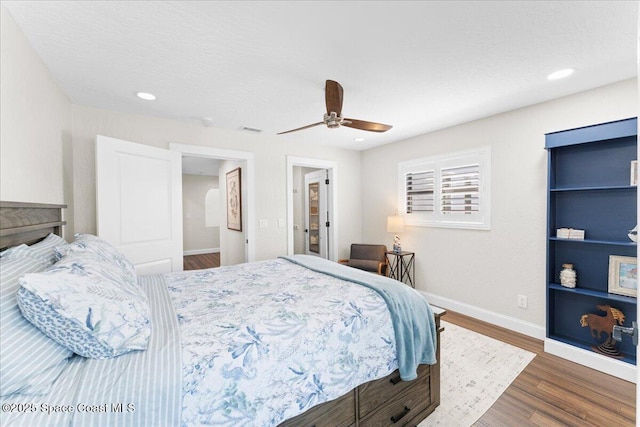 bedroom featuring visible vents, baseboards, a ceiling fan, wood finished floors, and recessed lighting