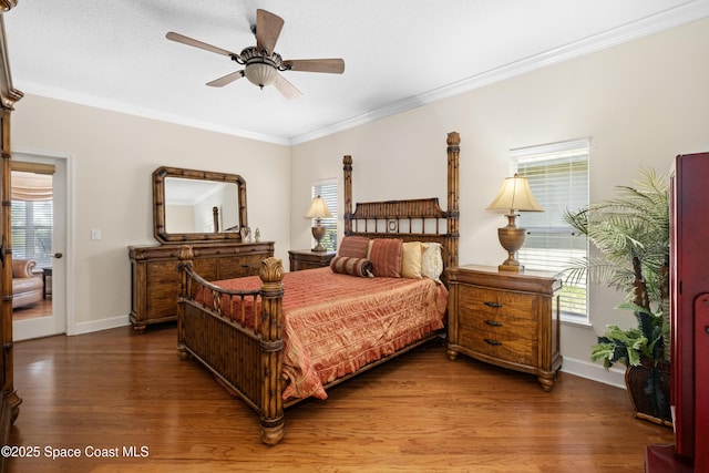 bedroom featuring ornamental molding, wood finished floors, and baseboards