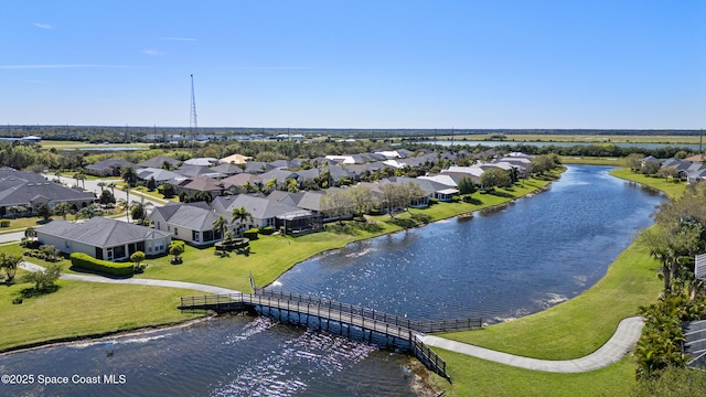 drone / aerial view with a water view and a residential view