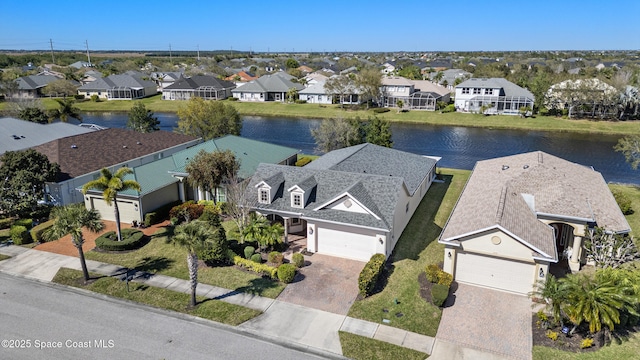 bird's eye view with a water view and a residential view