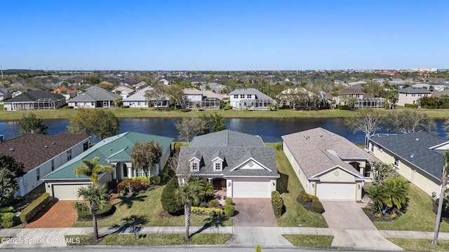 bird's eye view featuring a water view and a residential view