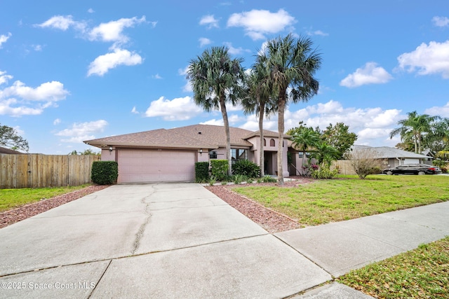 view of front facade with a garage, a front yard, concrete driveway, and fence