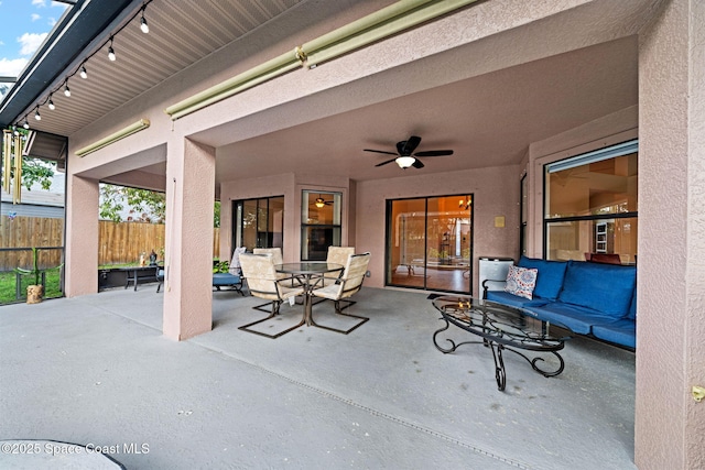 view of patio featuring outdoor dining area, fence, an outdoor hangout area, and ceiling fan