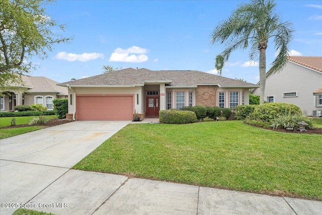 view of front of house featuring a front yard, a garage, driveway, and stucco siding